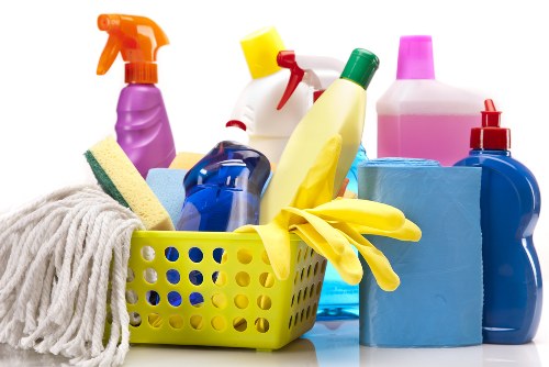Office cleaner tidying desks and communal spaces in a Ruislip business premises