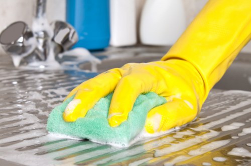 Local cleaner working in a kitchen and bathroom home cleaning routine